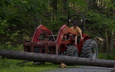 Chuck lifting a log with the Massey Ferguson tractor.