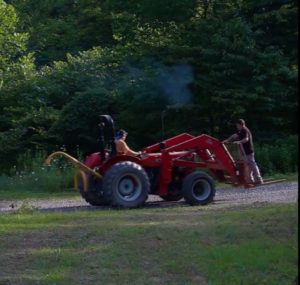 Mike getting a ride from Chuck on the tractor.