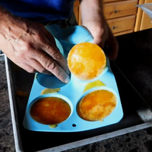 Remove frozen eggs from tray.