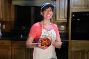 Bren in the homestead kitchen showing how to make a fast fruit salad.